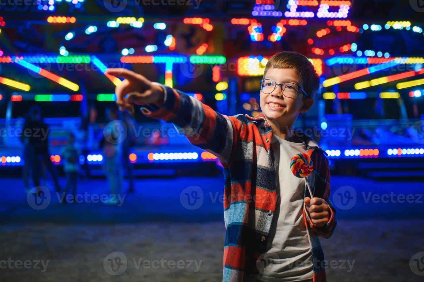 A handsome and happy boy is having fun in the amusement park photo