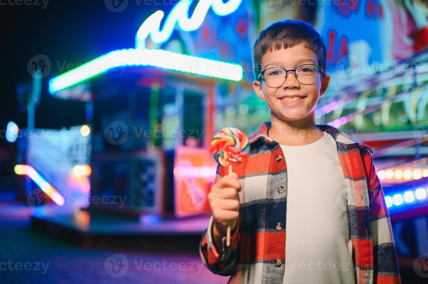 Happy boy in amusement park. Happy childhood concept photo