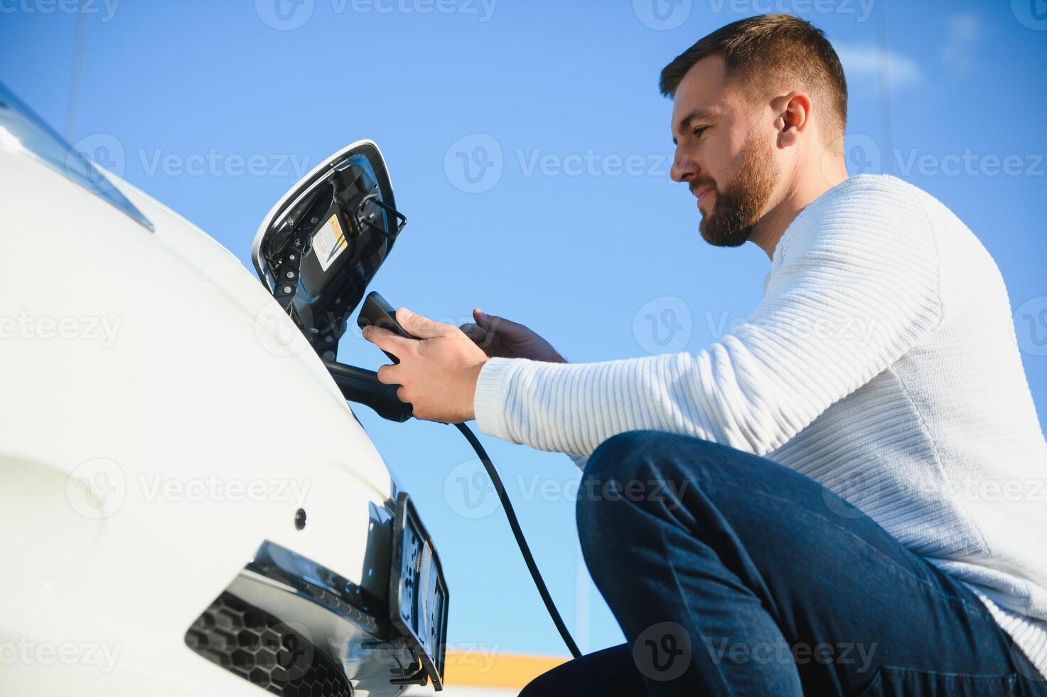 Man turning on charging of car photo