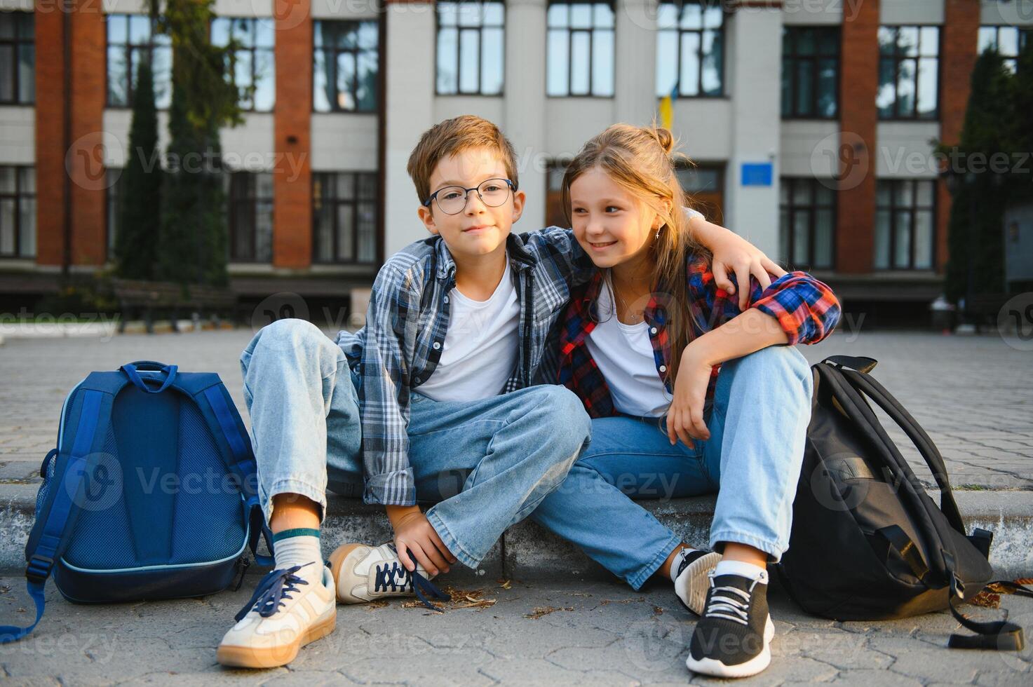 smartphone generation. schoolchildren use a smartphone on the street near the school photo