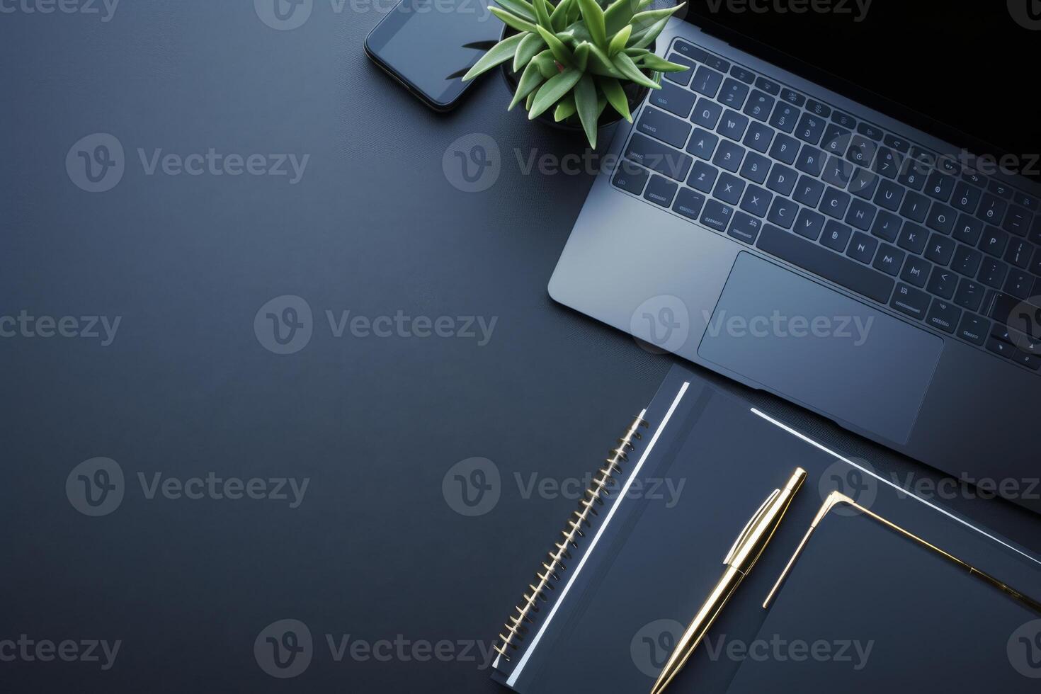 A sleek workspace featuring a laptop, notebook, and greenery for productivity and inspiration photo