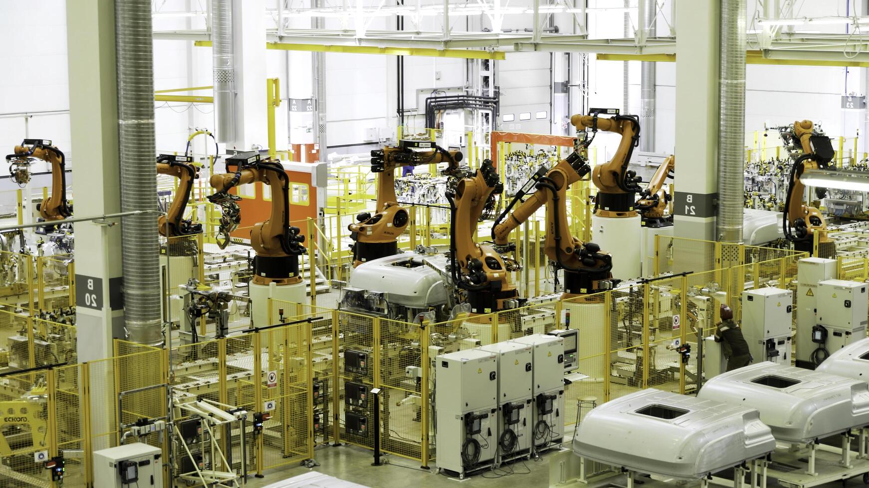 Moscow - Russia, 01.14.2022. automobile plant, modern production of cars. Scene. Robots at work, build process in automated production line. photo