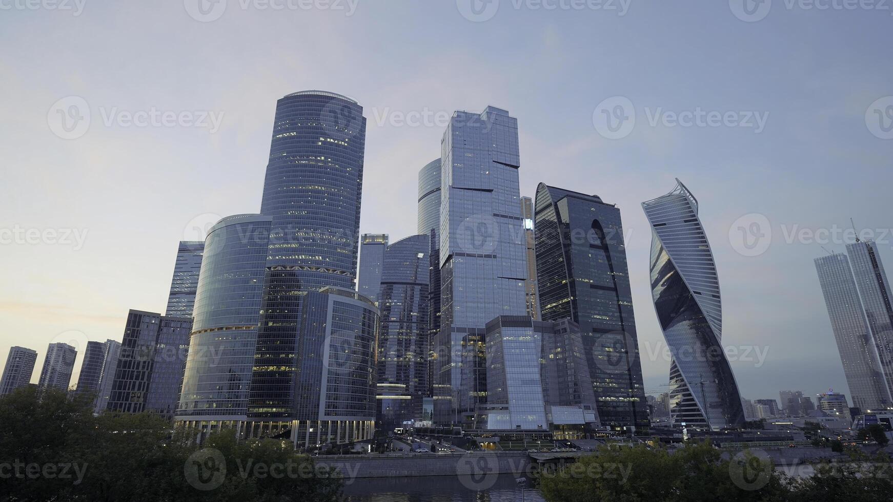 A developing business district in Moscow on Presnenskaya Embankment.Action. Large towers -office buildings with huge transparent windows on a background of grass photo