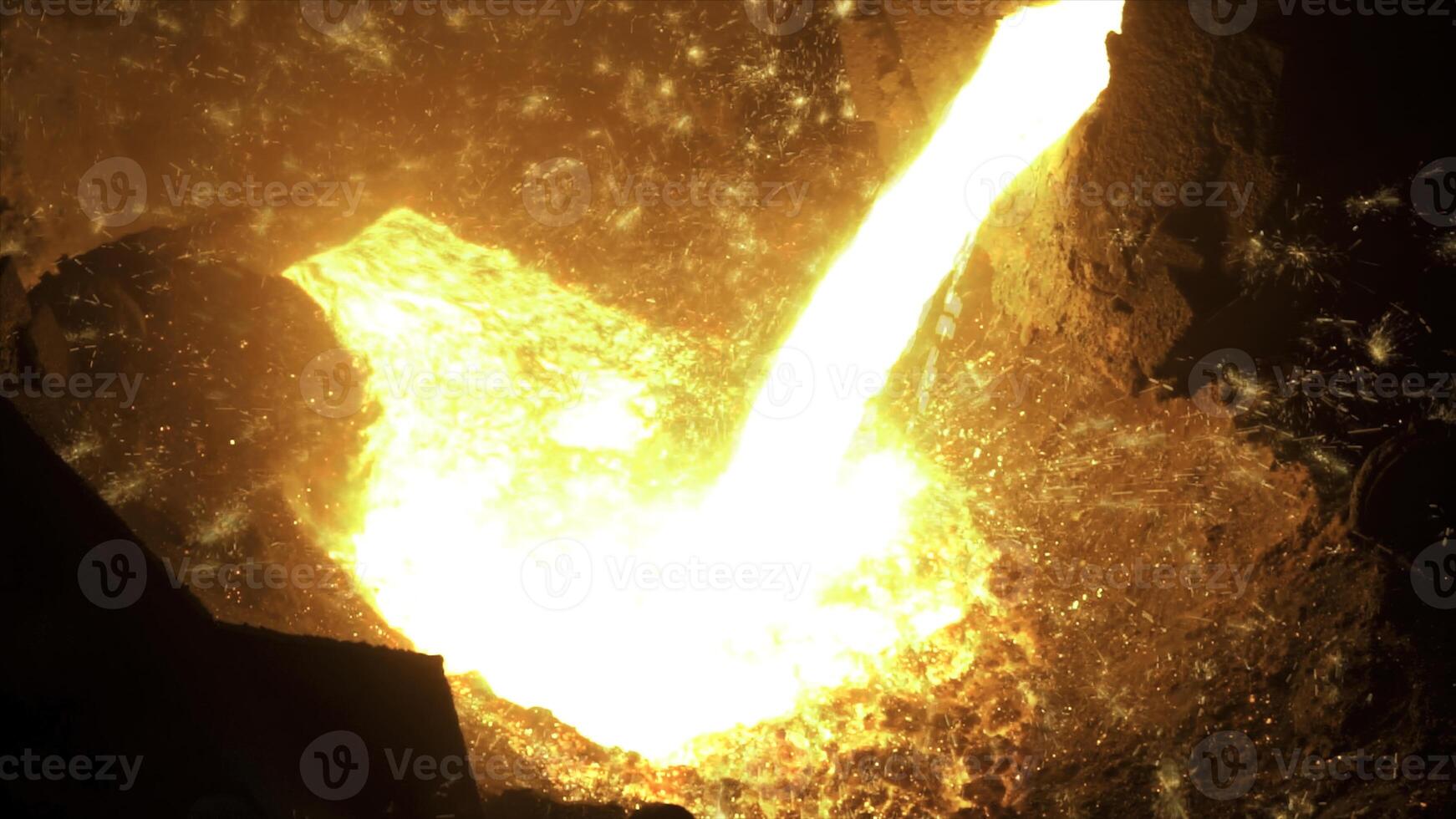 Sparks on black background from the process of pouring hot steel, heavy industry. Stock footage. Close up for iquid metal flowing from blast furnace. photo