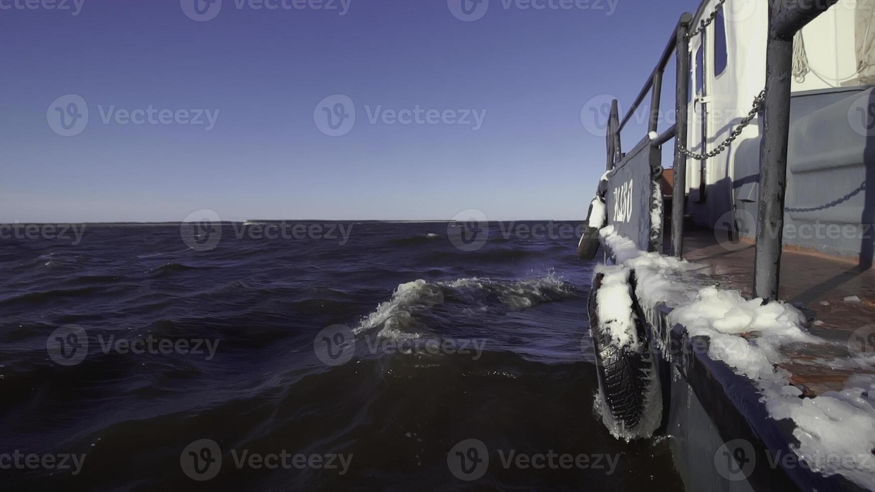 Fishing boat floats in the sea at sunset. Clip. View from the barge to the sea horizon. Romantic swim at dawn in the sea photo