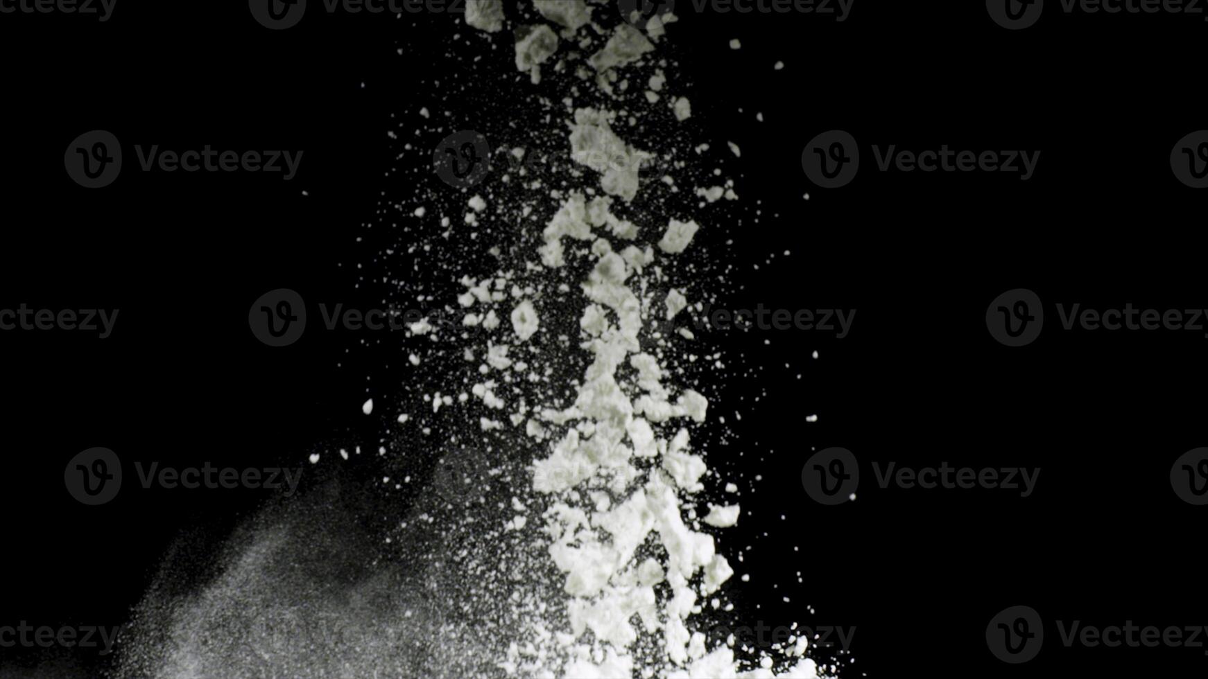 Splash of white powder isolated on black background. Stock footage. Close up for white abstract snow being thrown up. photo