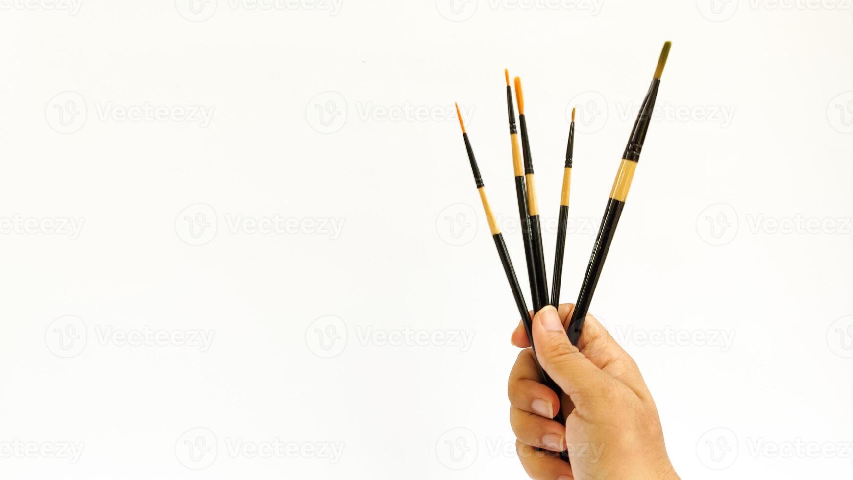 Different brushes with paints on white background photo