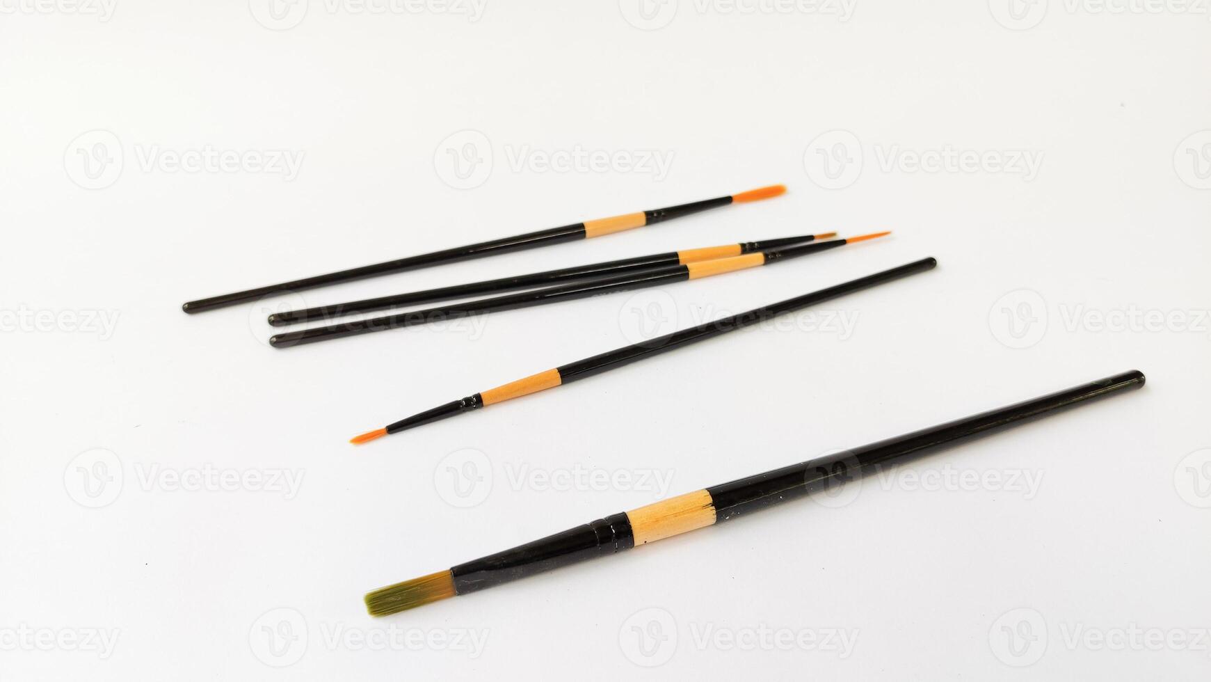 Different brushes with paints on white background photo