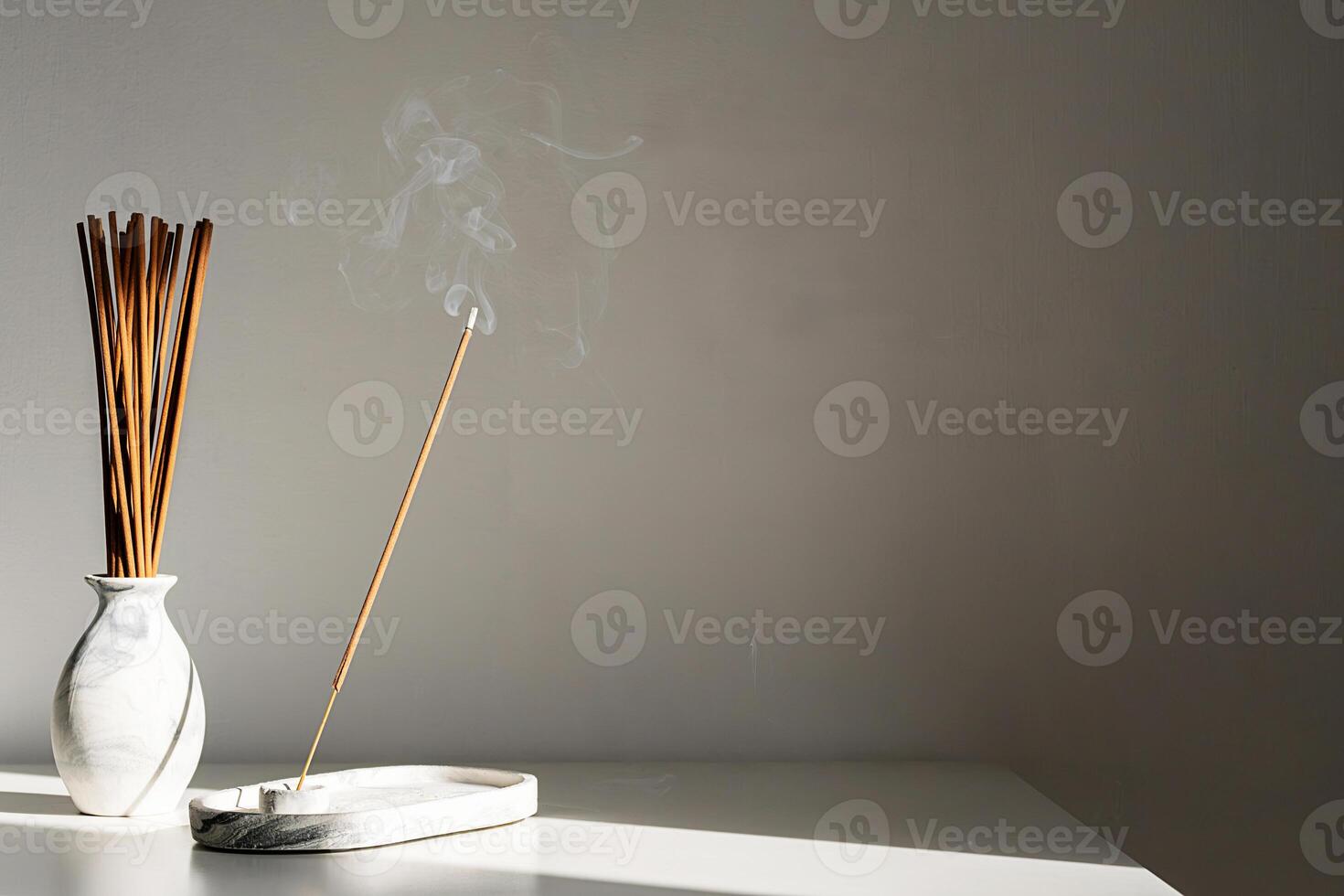 Elegant incense holder with sticks and smoke in minimalist setting. photo