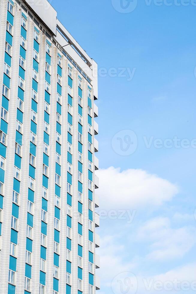 Modern building facade against cloudy sky. Urban architecture and design concepts. photo