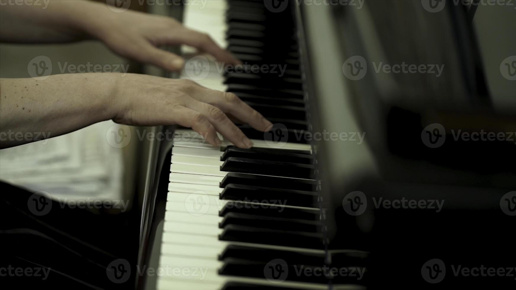 Girl's hands on the keyboard of the piano. The girl plays piano,close up piano. Hands on the white keys of the Piano Playing a Melody. Women's Hands on the keyboard, Playing the Notes Melody. photo