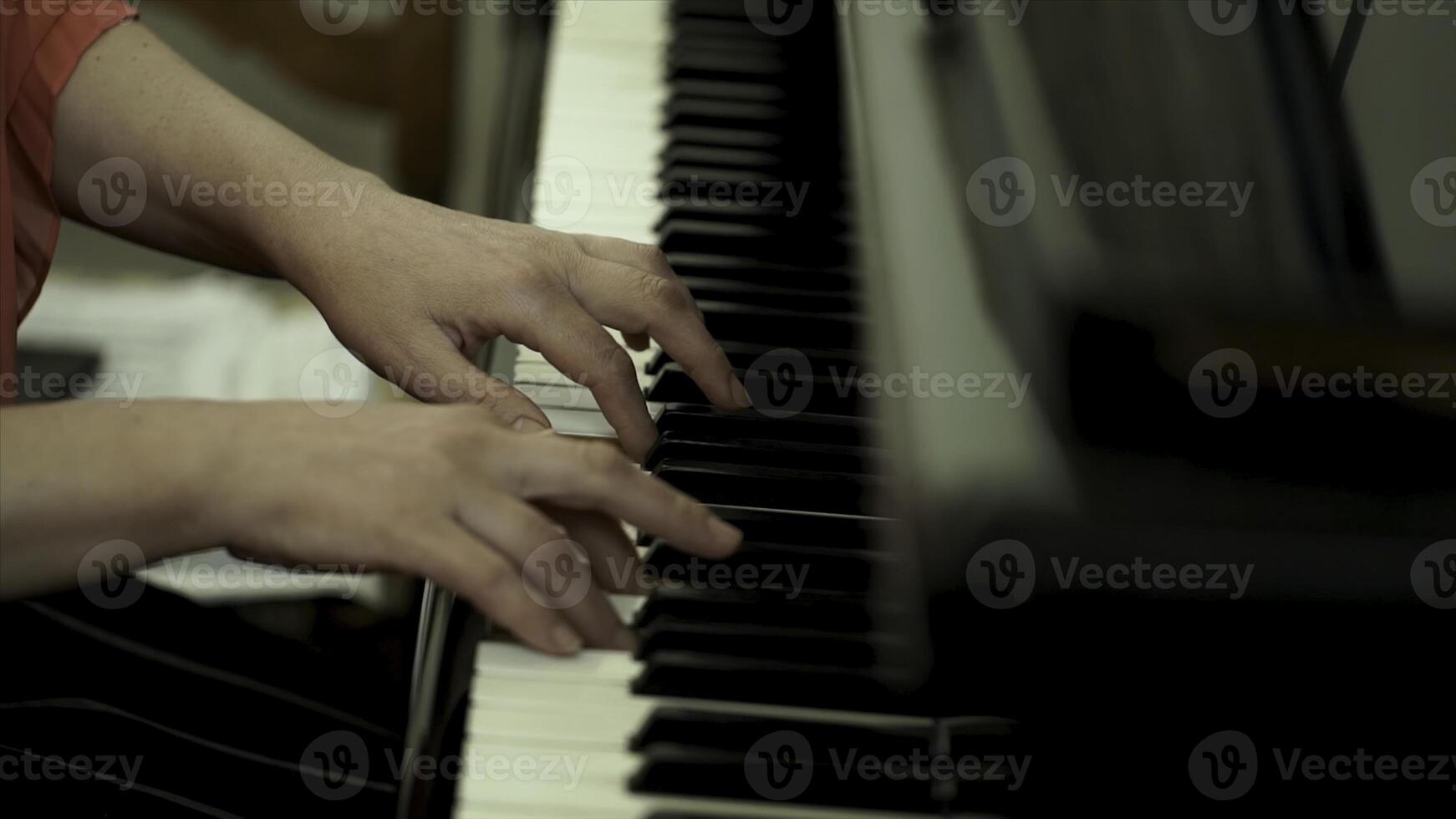 Girl's hands on the keyboard of the piano. The girl plays piano,close up piano. Hands on the white keys of the Piano Playing a Melody. Women's Hands on the keyboard, Playing the Notes Melody. photo