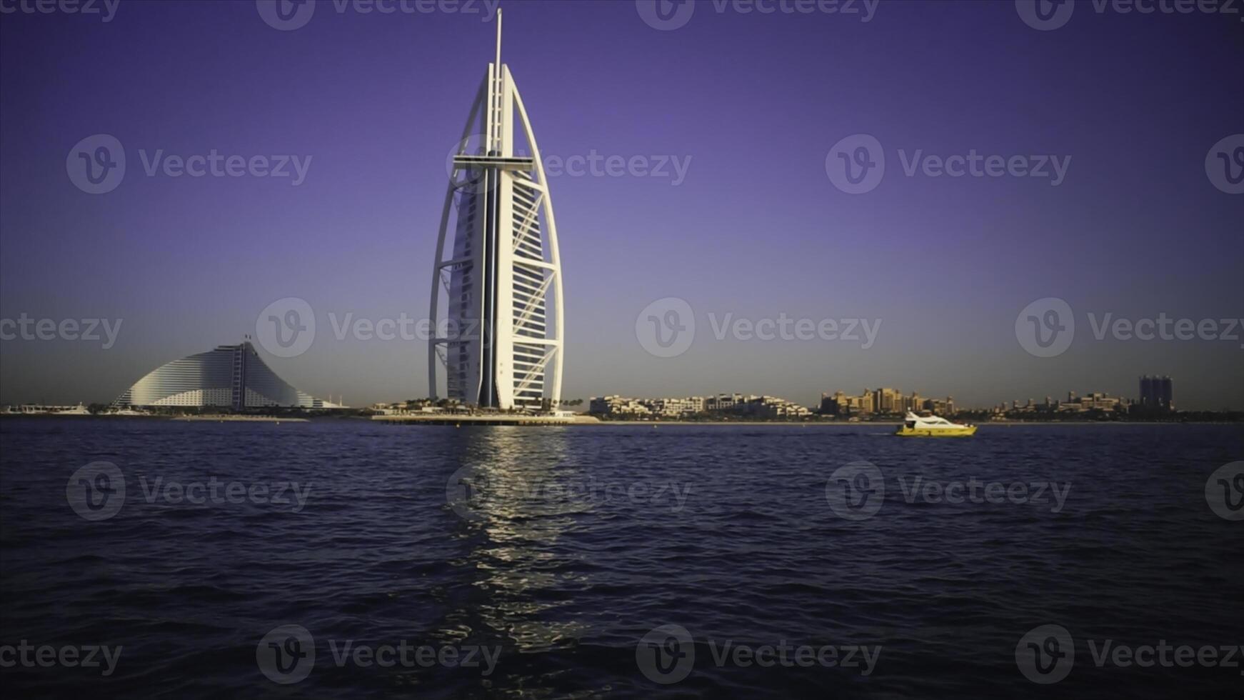 A landscape view of Dubai beach and sea in summer. Stock. Famous building and fishing boats background. UAE photo