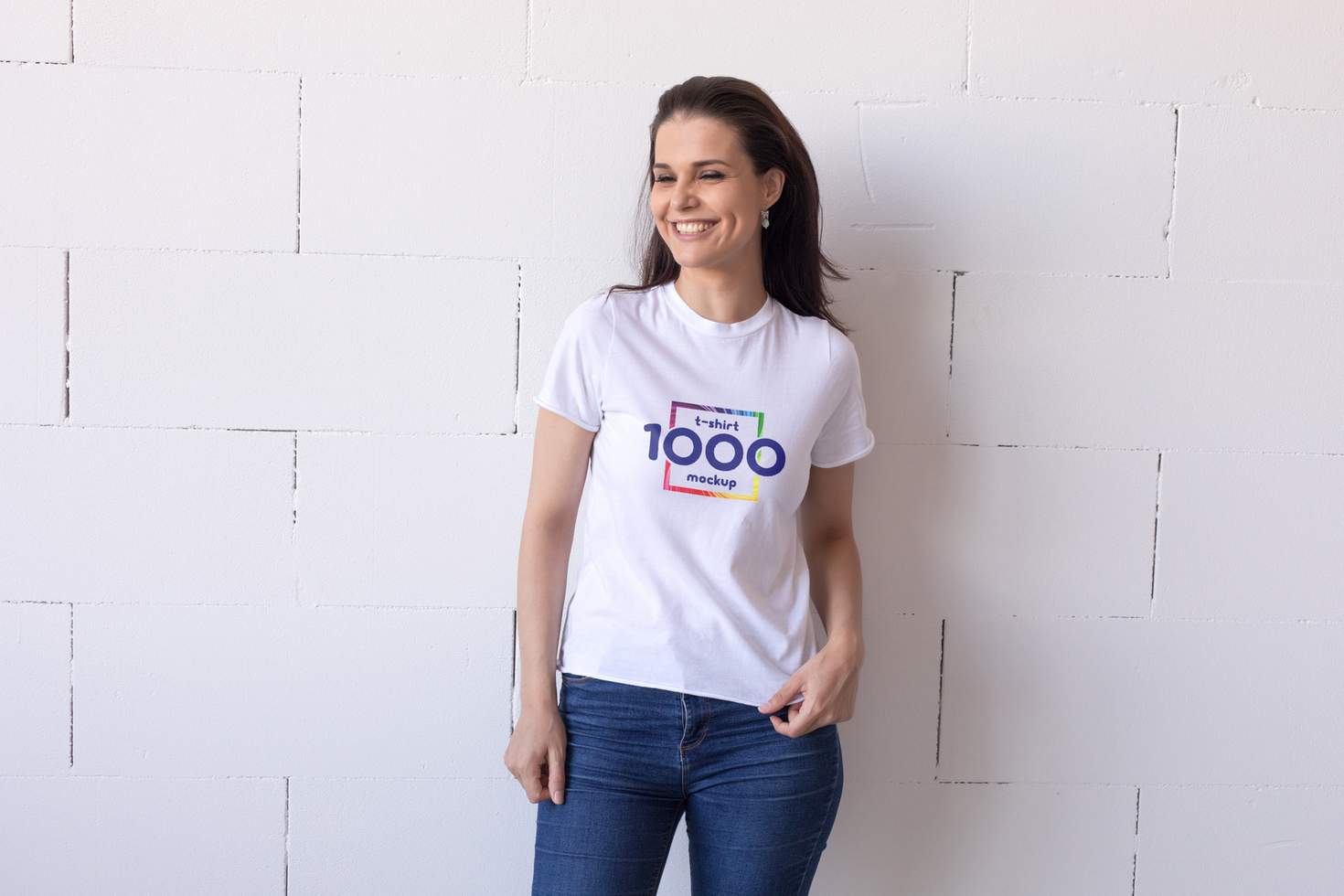 Woman wearing a white t-shirt mockup with text and design, smiling at the camera. psd