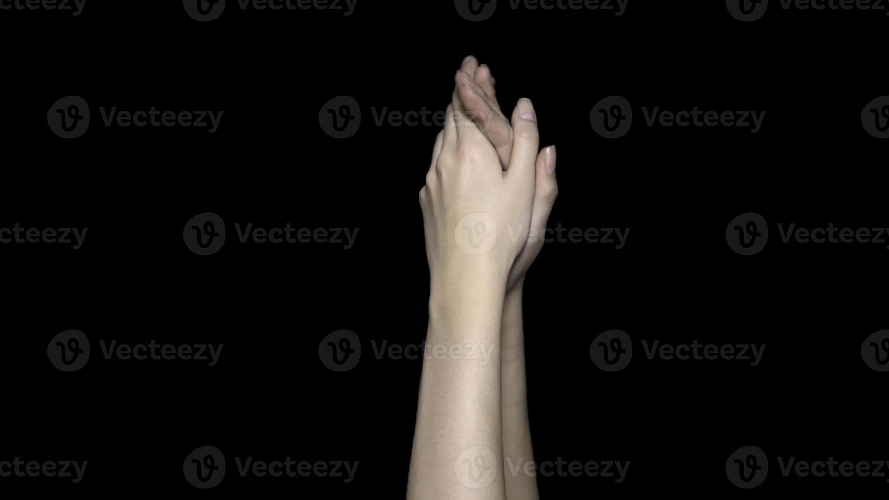 Hands applauding isolated on a black background. Clapping hands over a black background photo