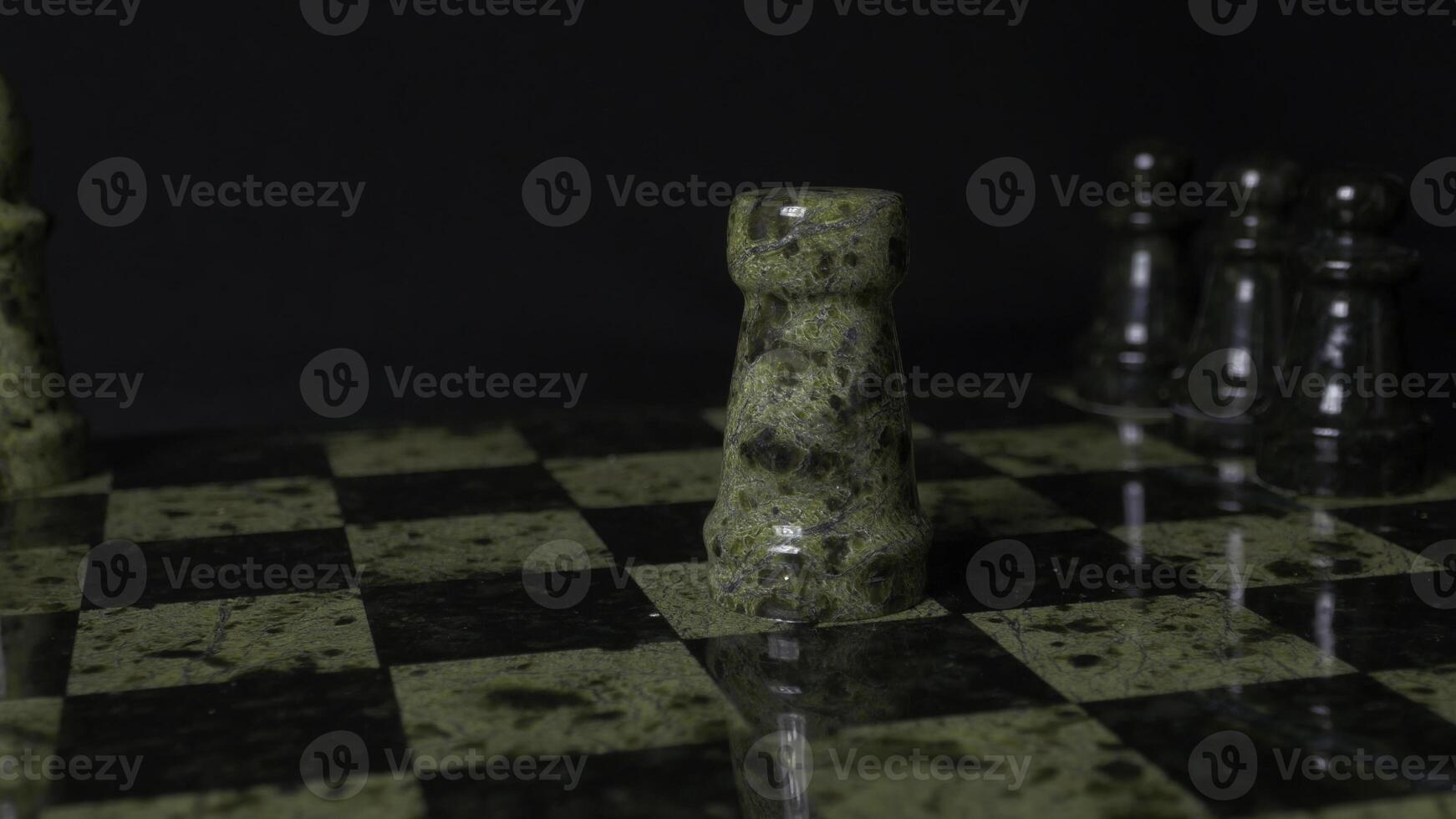 White Rook beats black Elephant on chessboard. Defeated chess Rook. Elephant holding woman's hand. Selective focus, close up view. Vintage toning. A rook in chess defeats elephant. photo