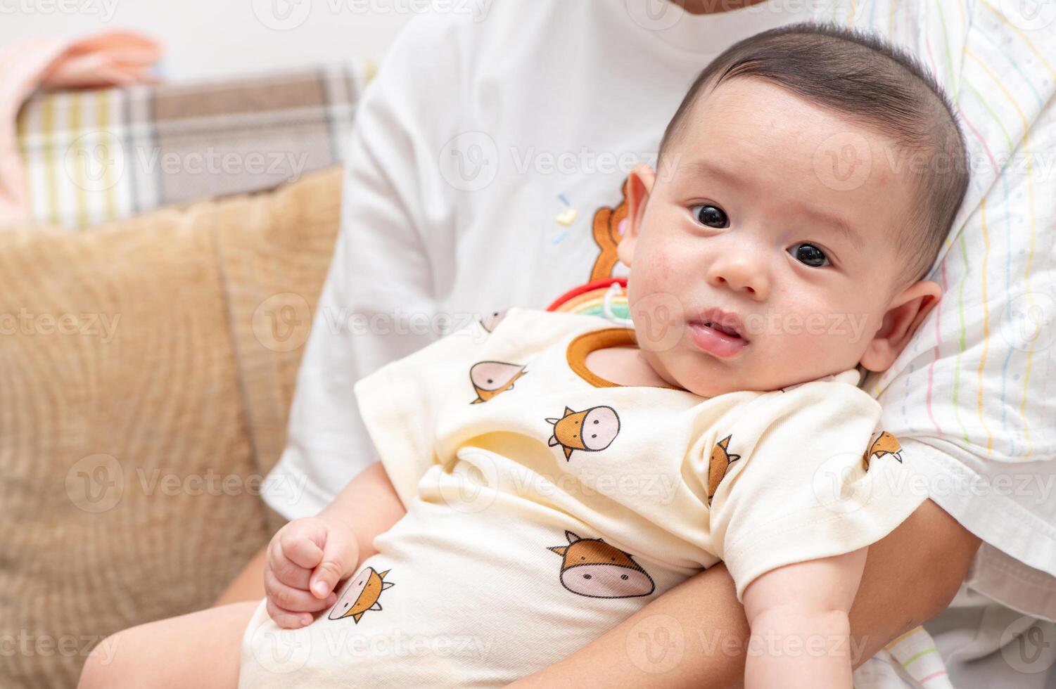 cute cheerful baby in mother hand. emotion infant photo