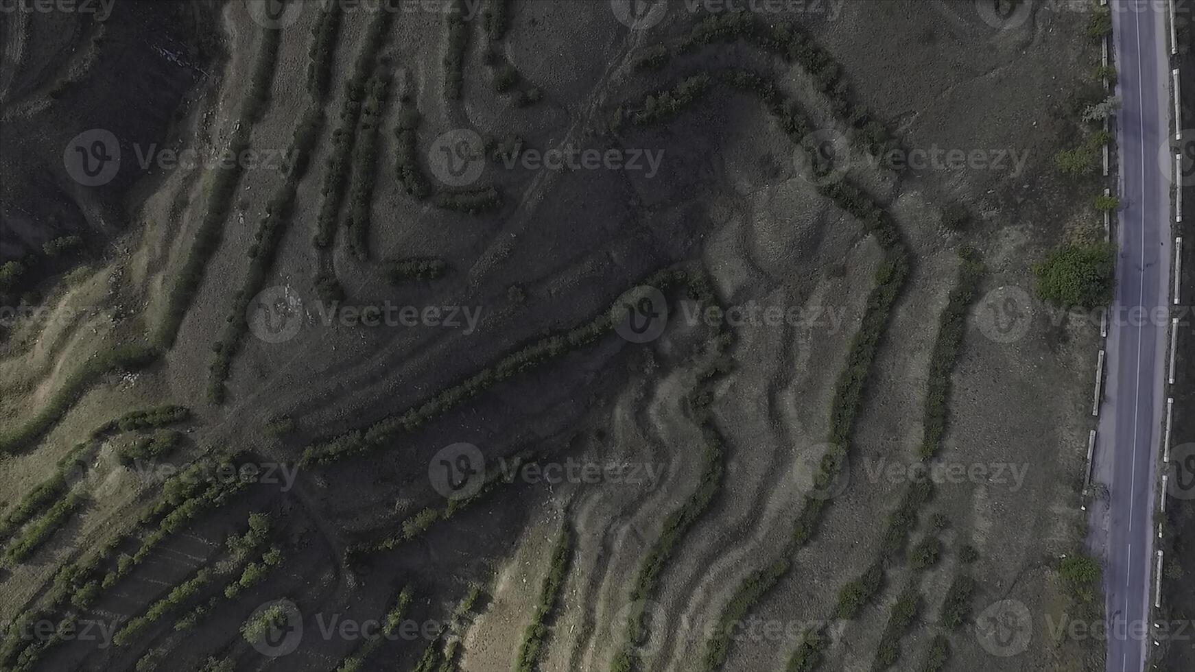 Aerial view of agricultural fields in the mountains with blue sky background. Shot photo