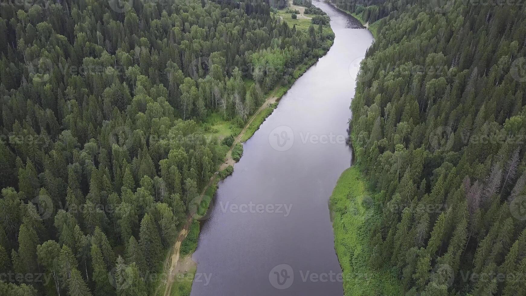 river flowing in the forest. Aerial view. Clip. Aerial view the forest lake during summer day. White clouds are over horizon. Aerial view of a green landscape with a river photo