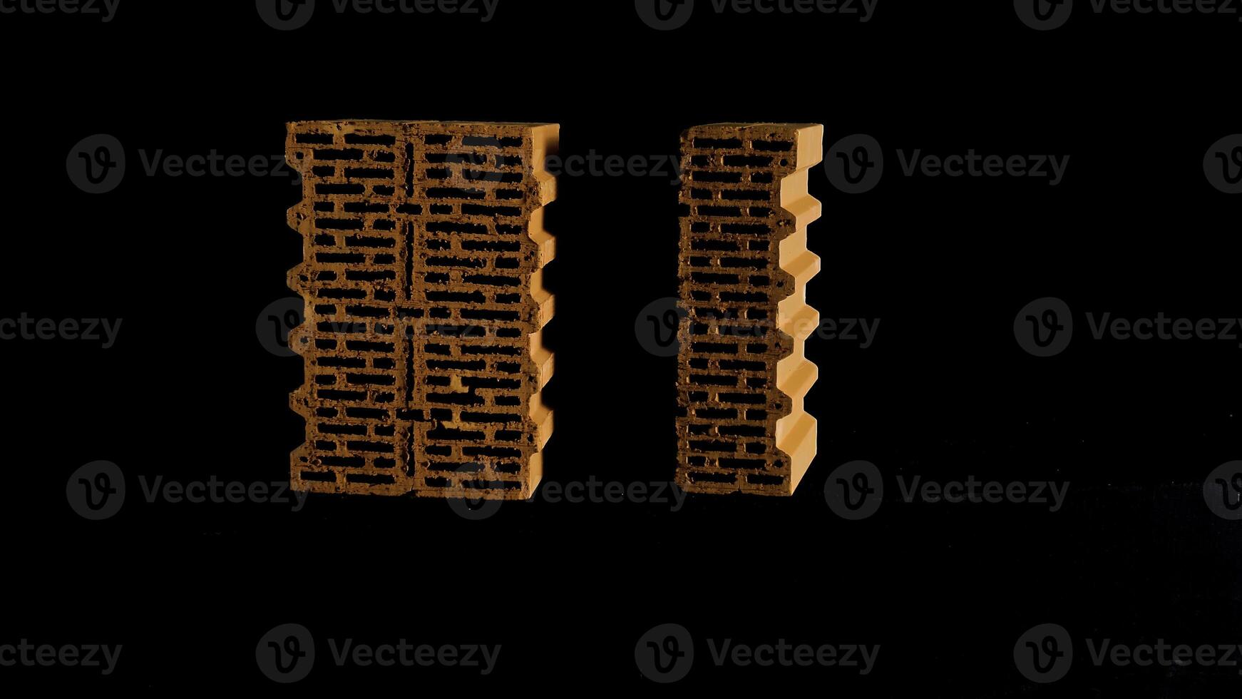 Close up of two red bricks moving against black background, construction and materials concept. Stock footage. New bricks isolated on black background. photo