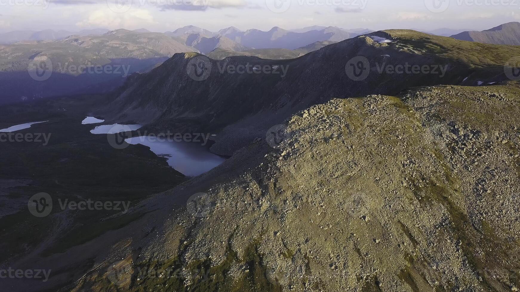 Aerial view on mountain peak with lake background. Amazing mountains landscape with ponds photo