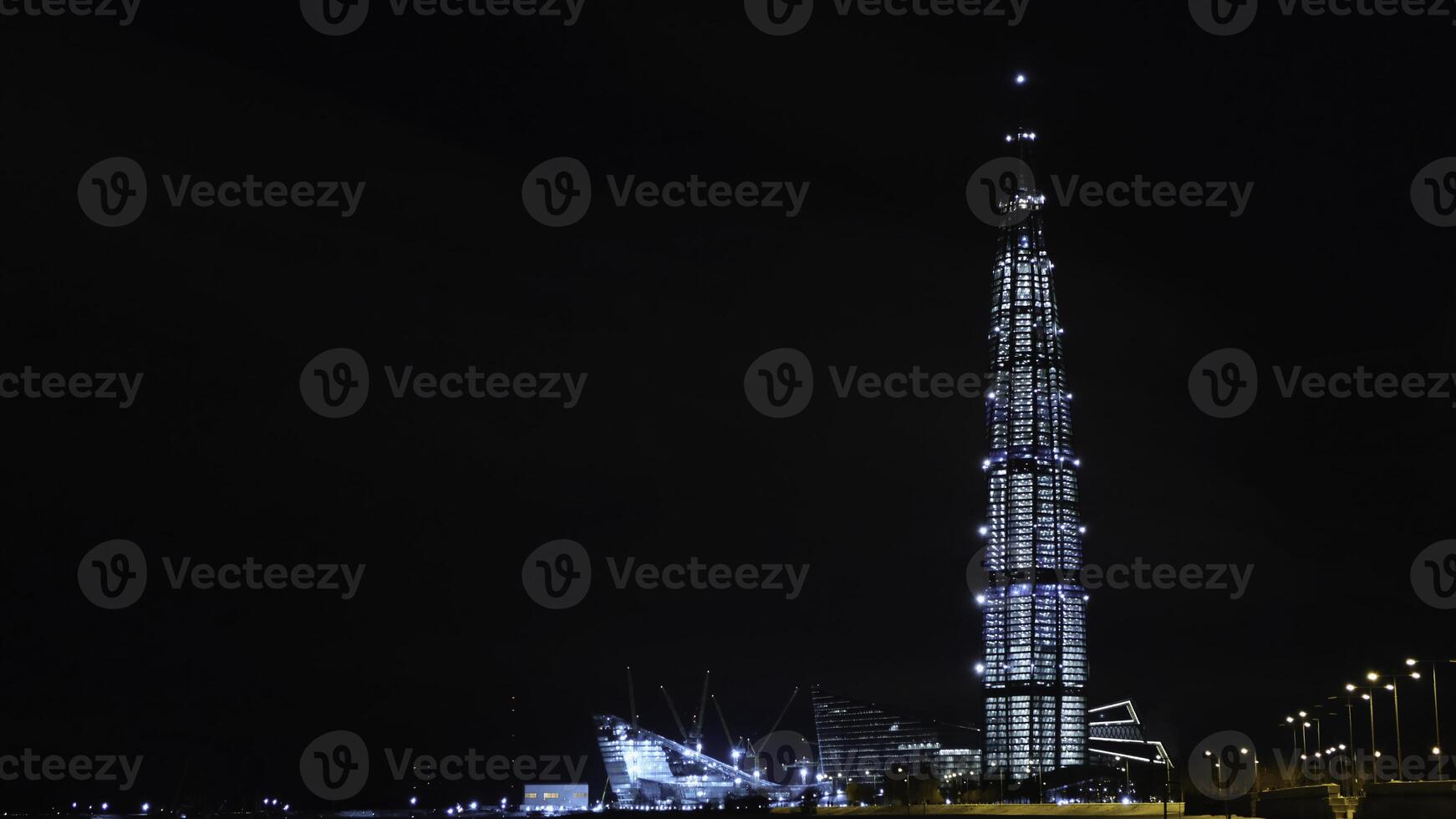 View from the bottom on the beautiful skyscraper Lahta center at night designed by award winning British Architect Tony Kettle. Concept. The Europe's highest tower photo