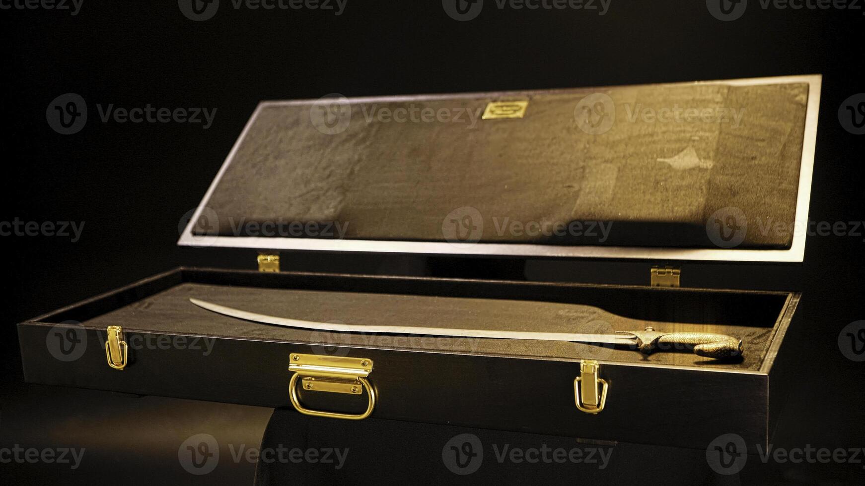 Exhibit in museum is old saber on isolated background. Stock footage. Old saber is in open suitcase as exhibit in museum of weapons or folk life photo