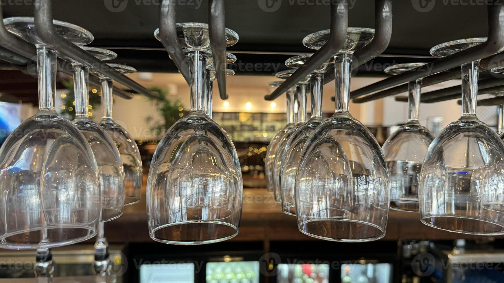 Hanging Wine Glasses in a Bar Setting photo