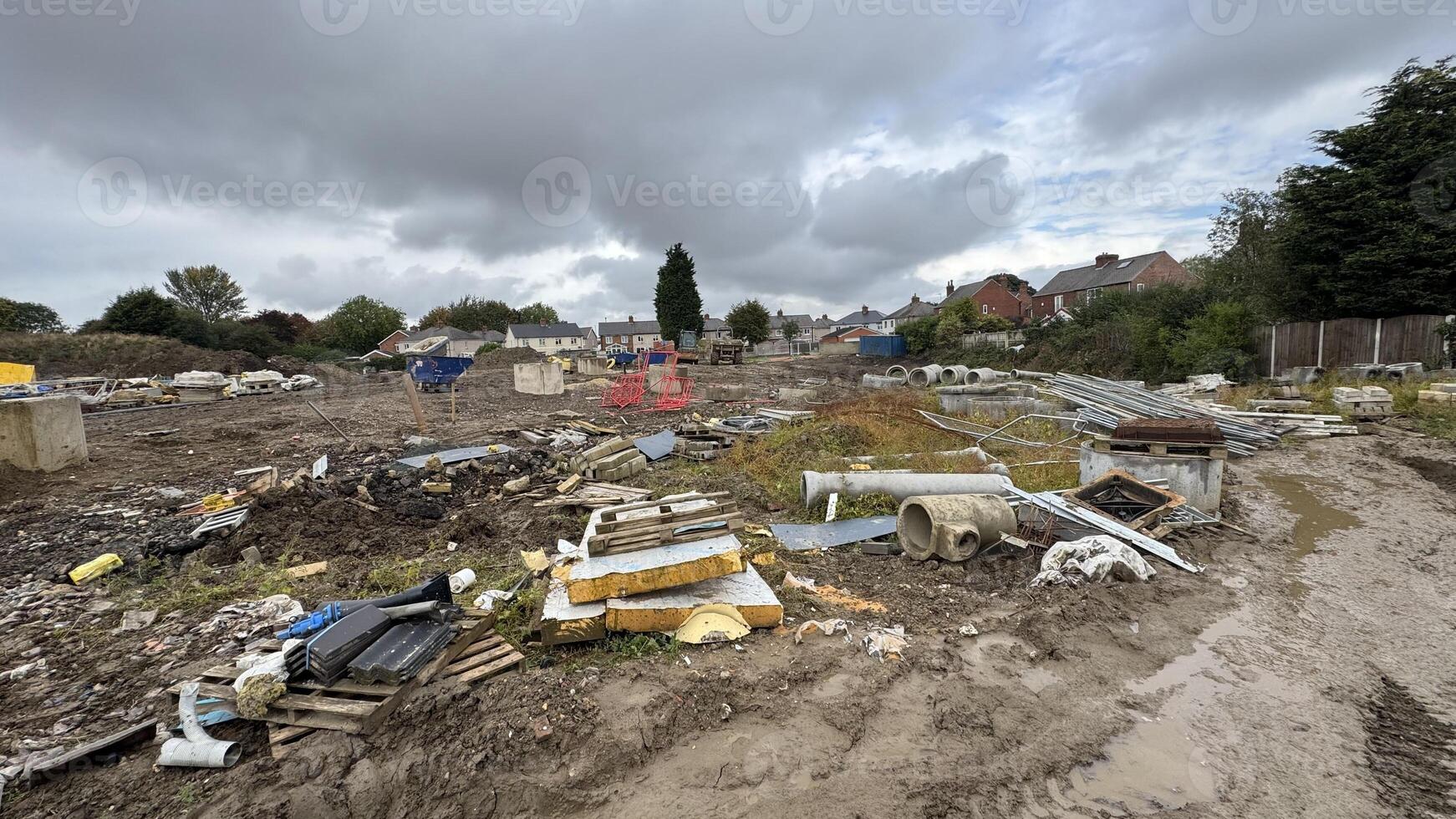 Abandoned Construction Site with Debris and Overgrowth photo