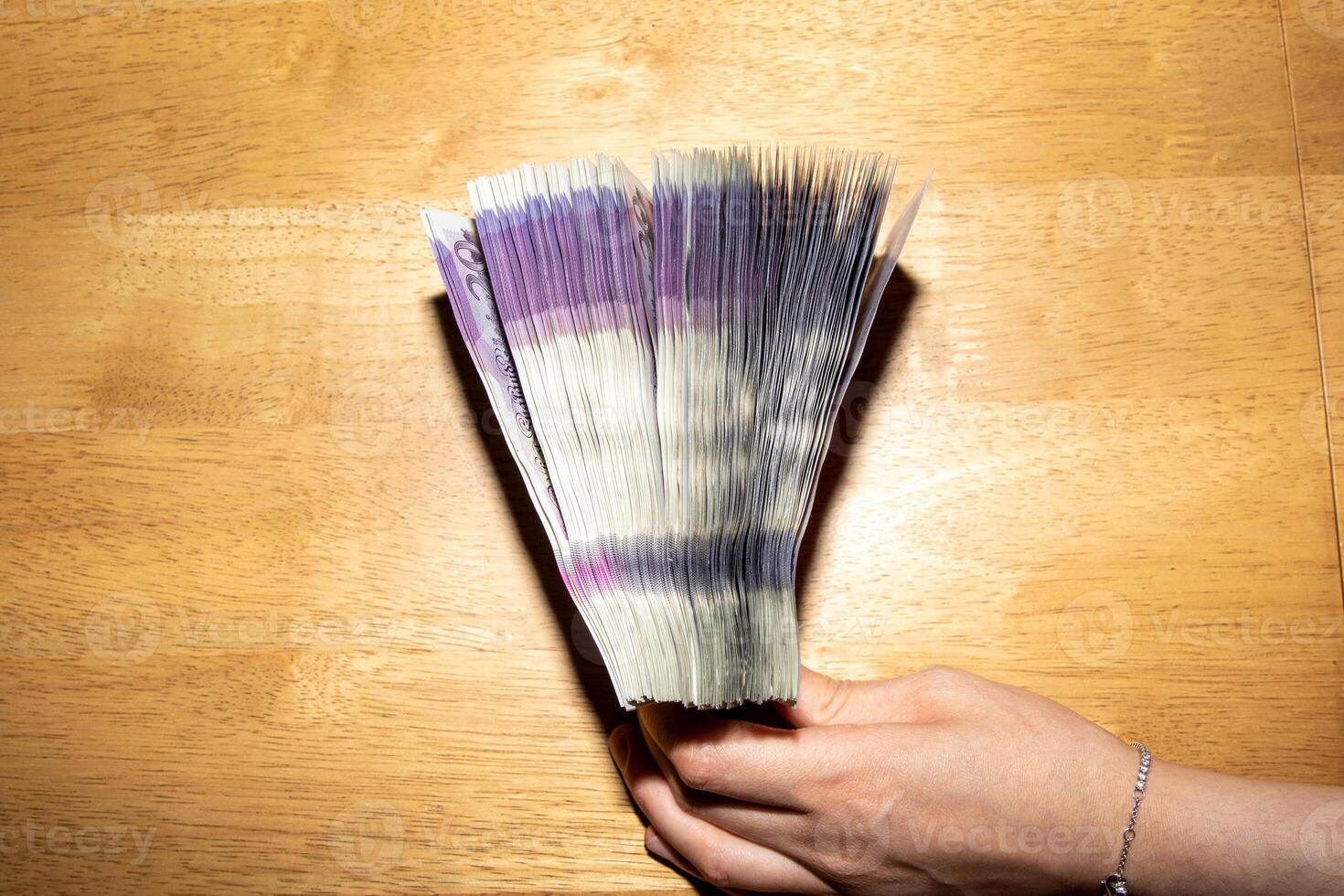 Hand Holding a Stack of Banknotes photo