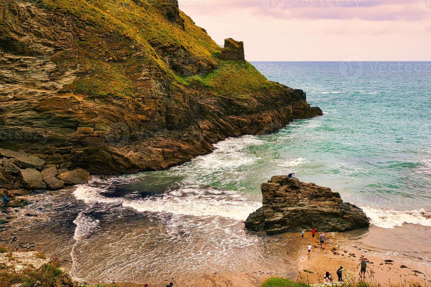 Scenic Coastal Beach with People Enjoying Nature in Tintagel, Cornwall, UK photo
