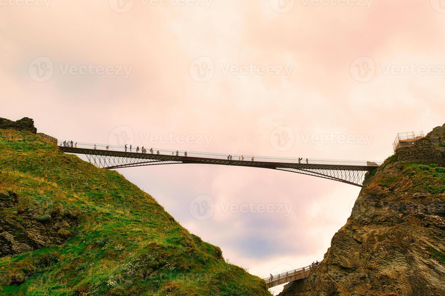 Bridge Connecting Cliffs with People Walking in Tintagel, Cornwall, UK photo