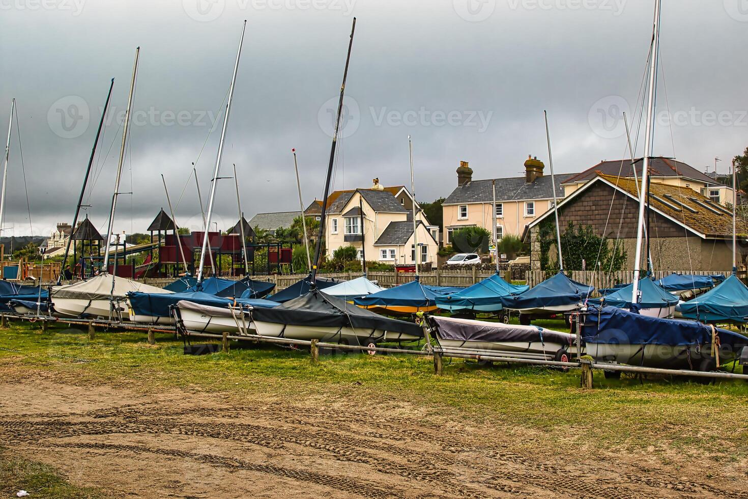 Sailboats on Grassy Shoreline with Cloudy Sky in Penzance, Cornwall, UK photo