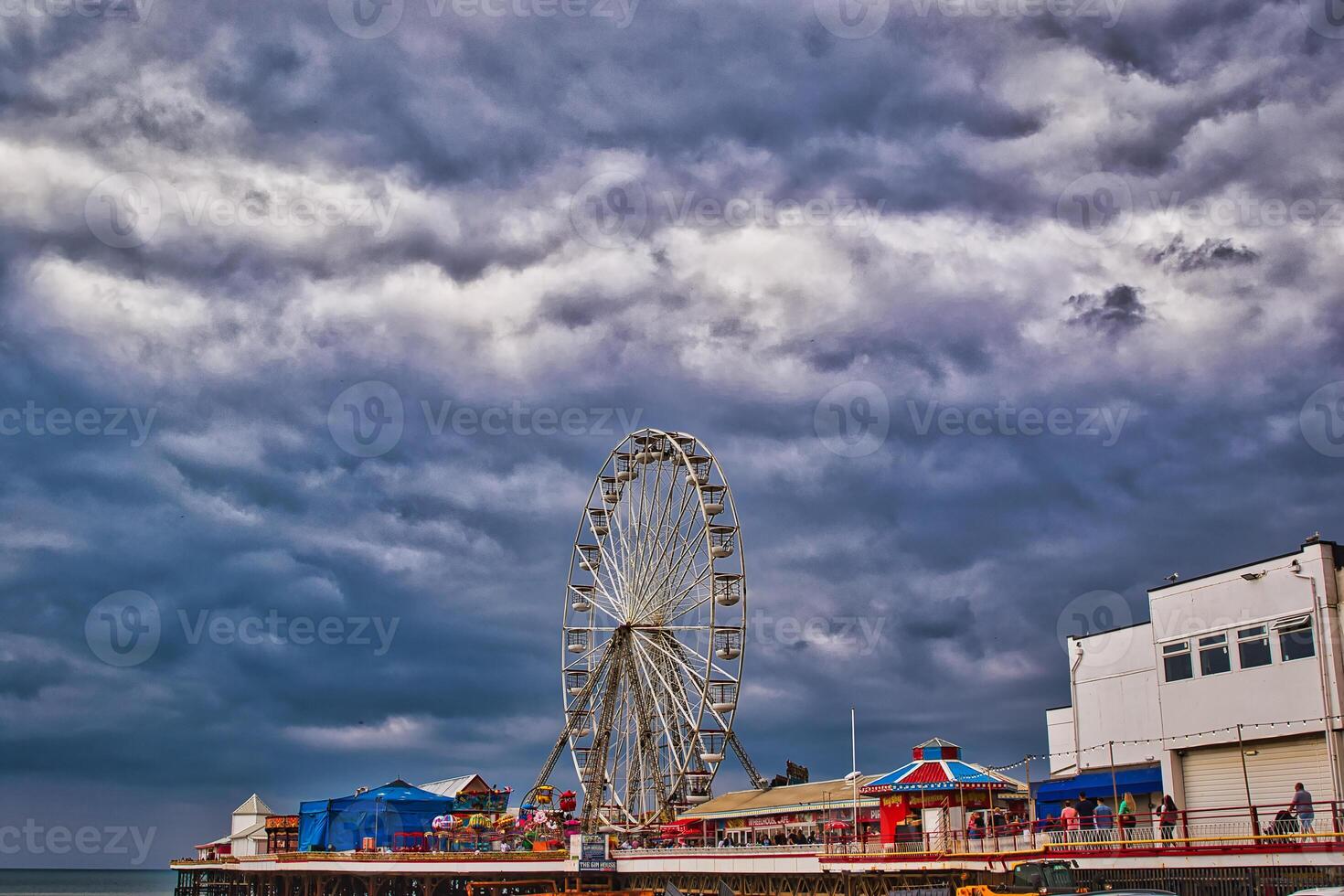 Ferris Wheel on a Pier Under Dramatic Skies in Blackpool, UK photo