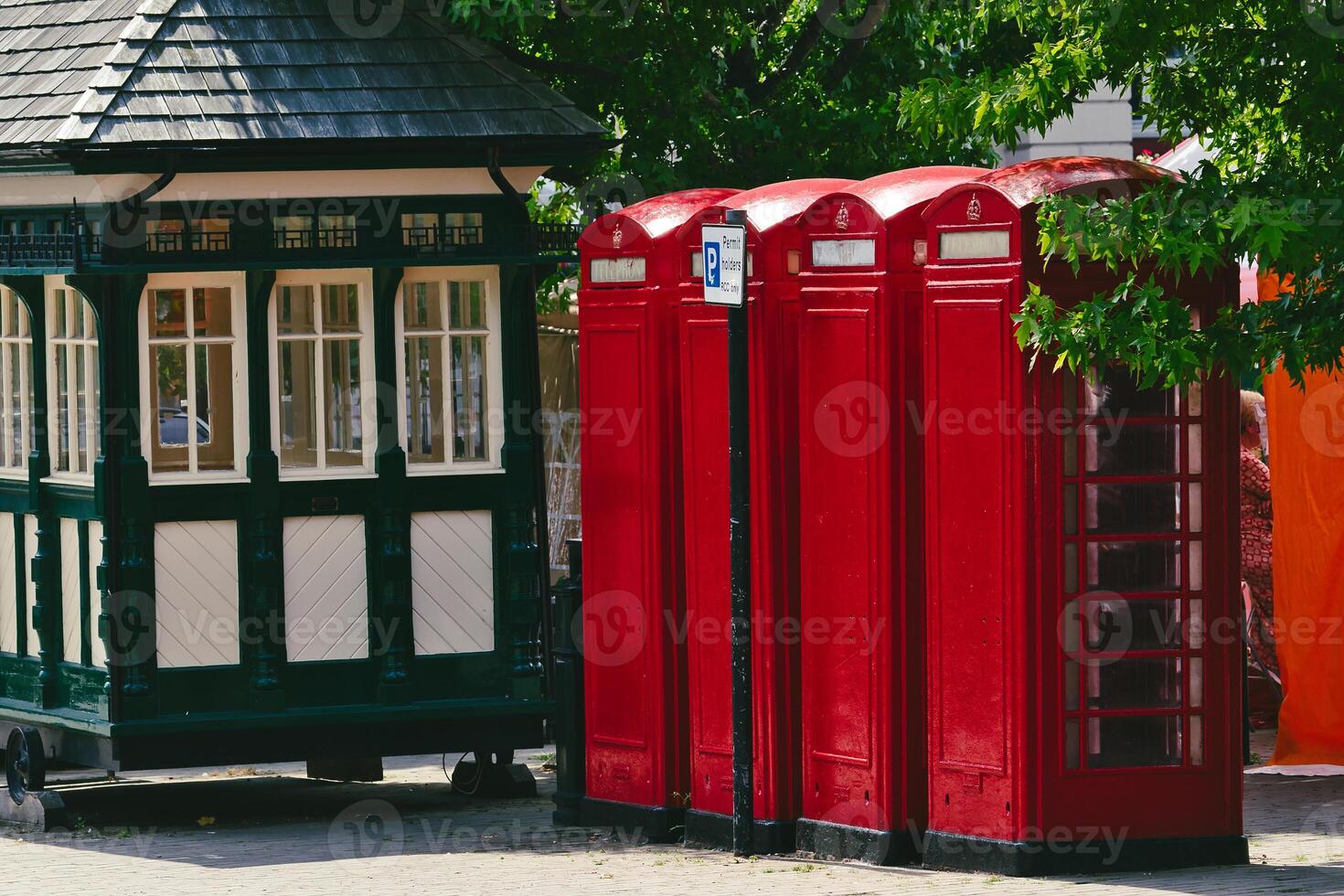 Charming Red Telephone Booths Next to Vintage Kiosk in Harrogate, UK photo