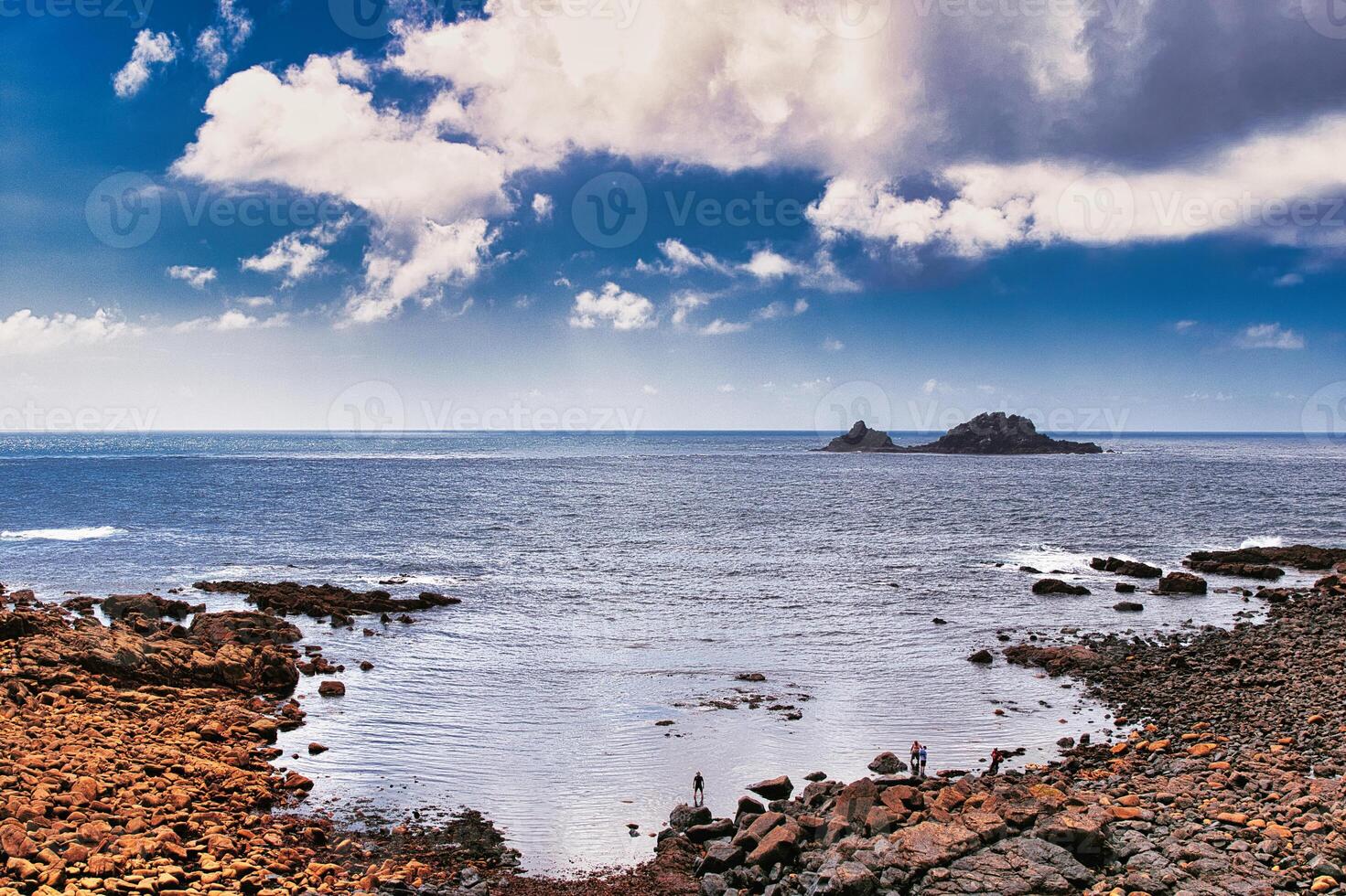 Scenic Coastal View with Rocky Shores and Distant Island at Cape Cornwall photo