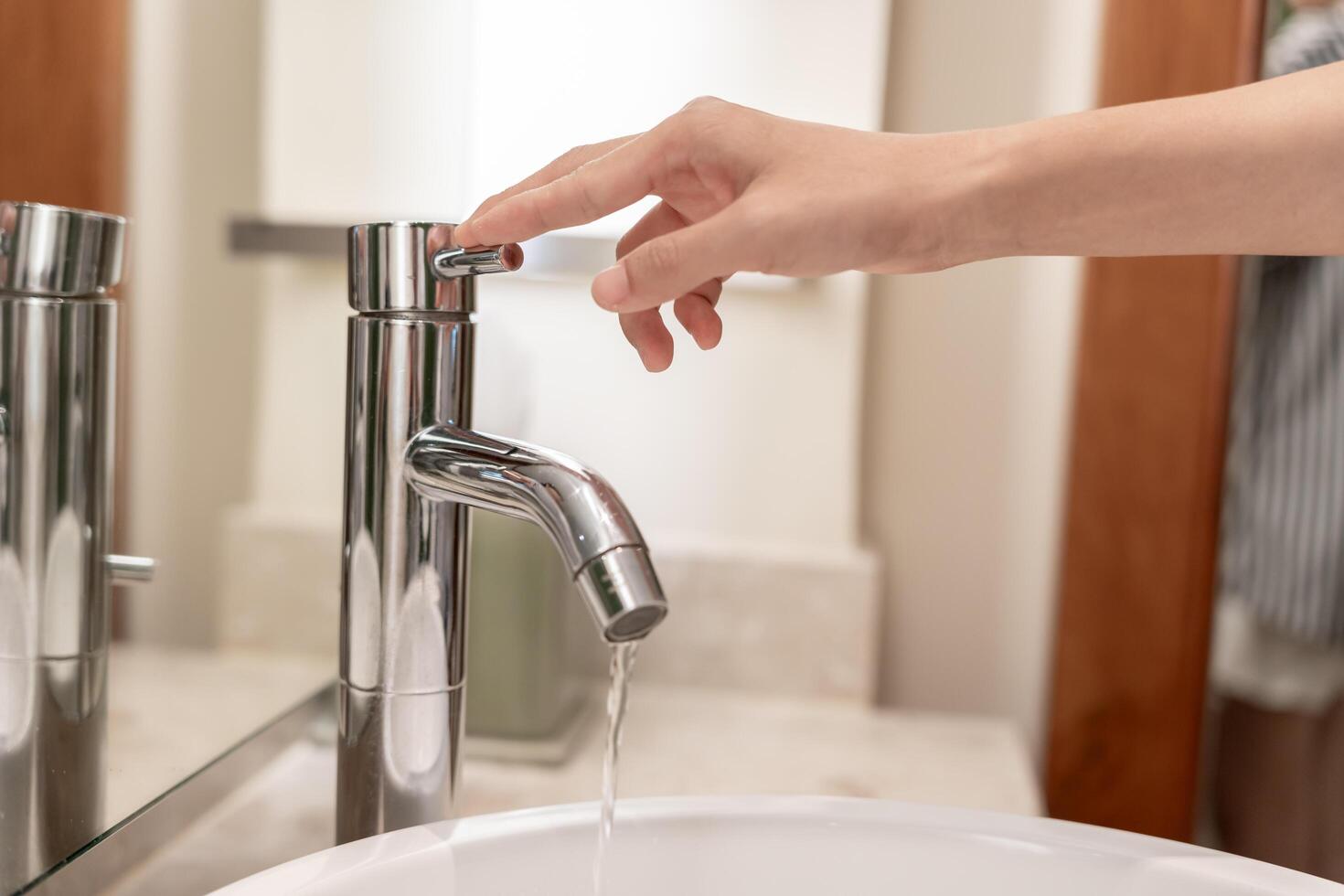 Save water. Volunteer keeps turning off the running water in the bathroom to protect environment. Greening planet, reduce global warming, Save world, life, future, risk energy, crisis , water day. photo