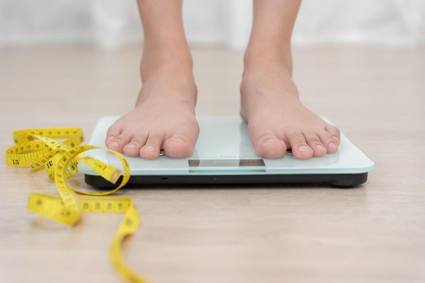 Diet woman on weight scale, results of diet. Beautiful shape. reduced waist size after under going a weight loss corse. balance, control, routines, exercise photo