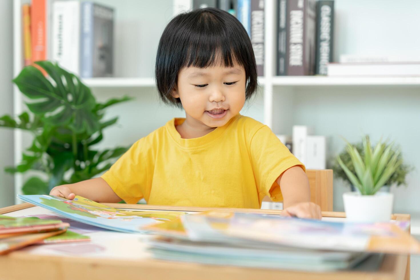 Happy Asian children relax read book at home. daughter and reading a story. learn development, childcare, laughing, education, storytelling, practice, imagine, reduce addiction mobile phone photo