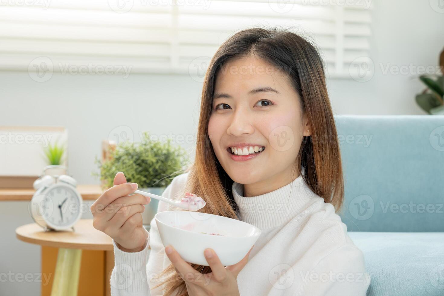 healthy food. Beautiful female girl enjoy eat yogurt, granola, fresh fruits on breakfast health in house. Happy young woman smile on morning good emotion. dieting, detox, diet, clean eat, vegetarian photo