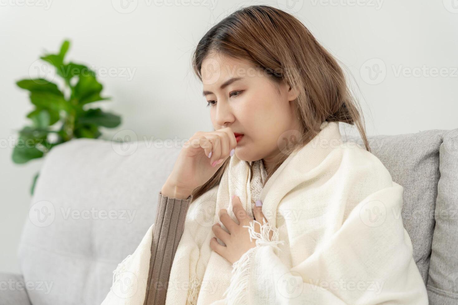 sick woman with a headache sitting under blanket, female sneezing and runny nose with seasonal influenza, allergic, high fever and influenza, resting, virus, coronavirus, feel illness, respiratory photo