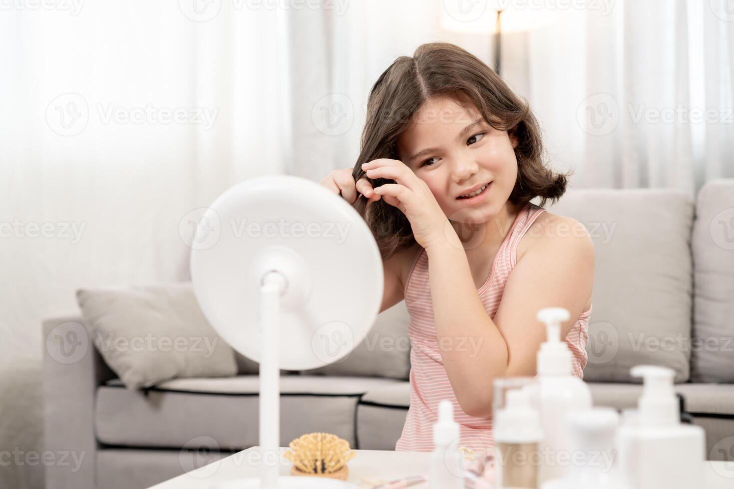 Happy children sit in front of a mirror makeup on face. Girl applying makeup. Advertisement, lifestyle , cosmetics, makeup accessories, beauty activity, beautician, talent, love beauty photo