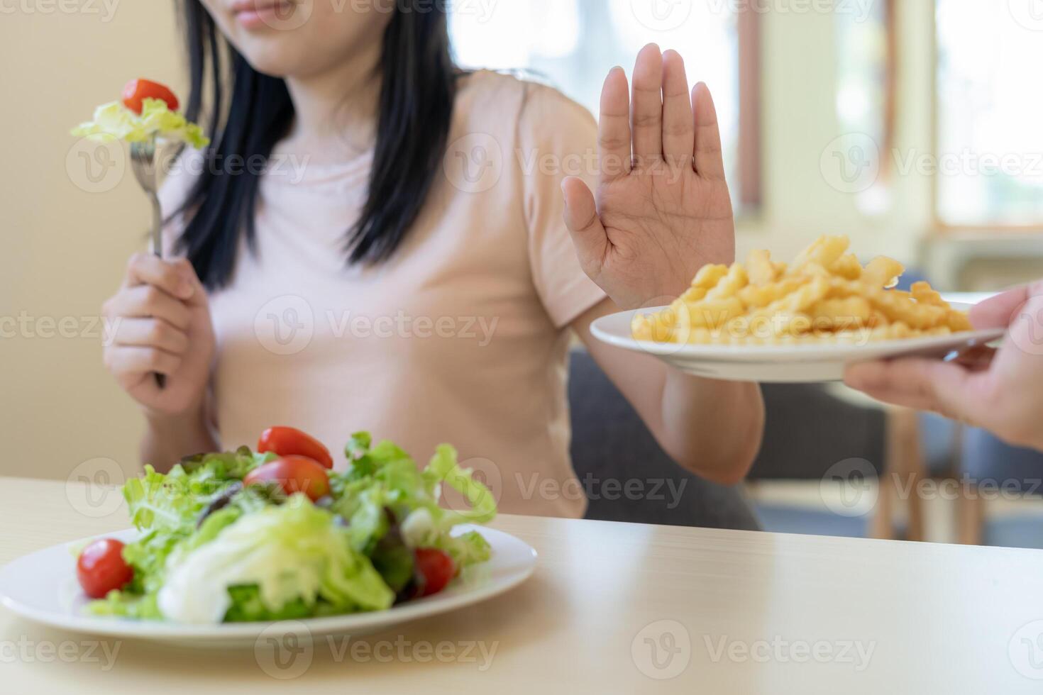 Beauty slim female body confuse French fries. Woman in restaurant achieves weight loss goal for healthy life, crazy about thinness, thin waist, nutritionist. Diet, body shape. photo