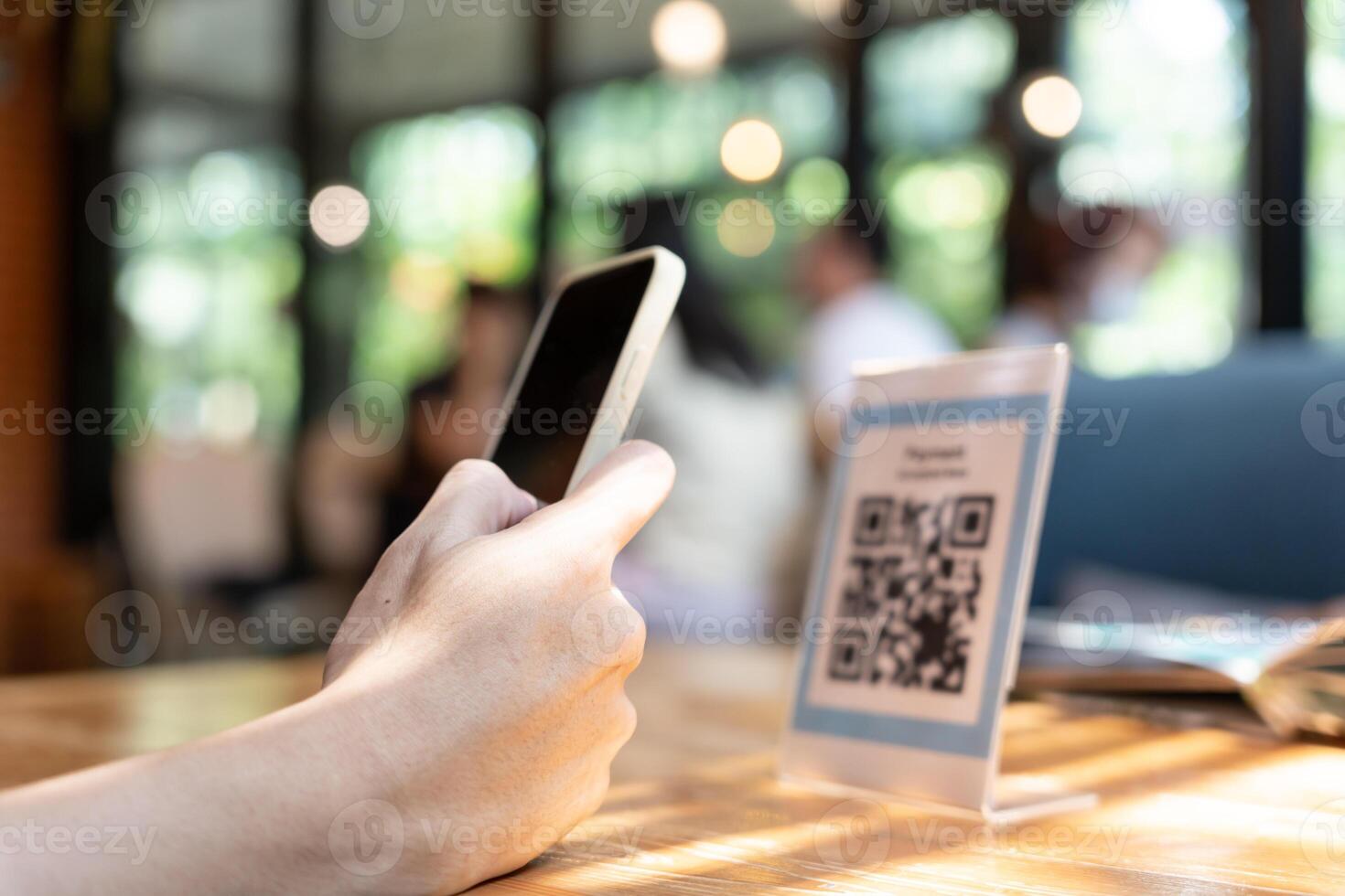 Woman use smartphone to scan QR code to pay in cafe restaurant with a digital payment without cash. Choose menu and order accumulate discount. E wallet, technology, pay online, credit card, bank app. photo