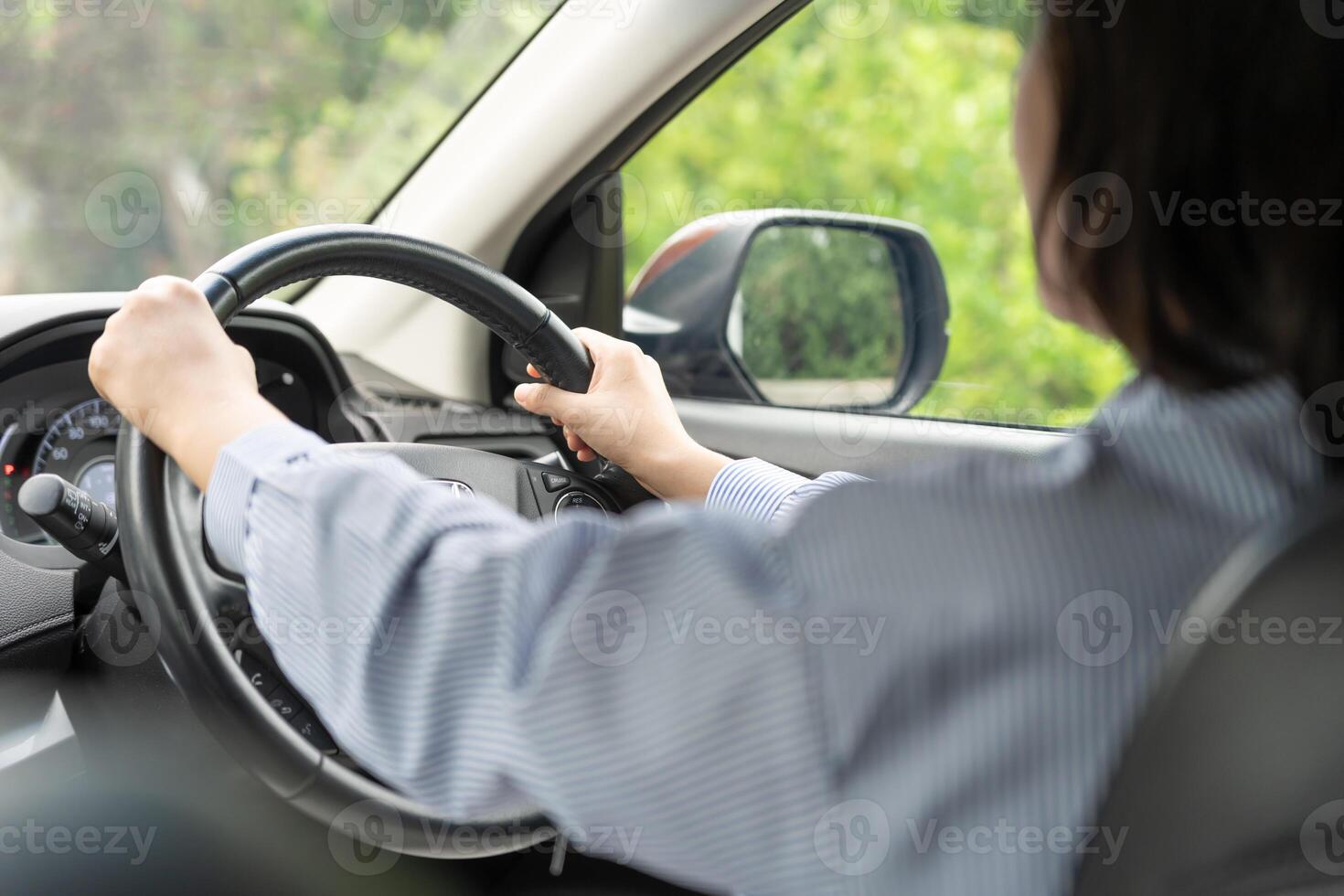 Woman use seatbelt and drives with intent, safe driving, driving practice, cheerful woman sits comfortably in the driver's seat with her hand confidently , readiness for a journey photo
