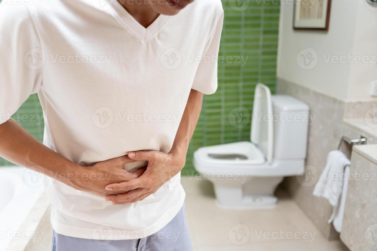 Constipation and diarrhea in bathroom. Hurt man touch belly stomach ache painful. colon inflammation problem, toxic food, abdominal pain, abdomen, constipated in toilet, stomachache, Hygiene photo