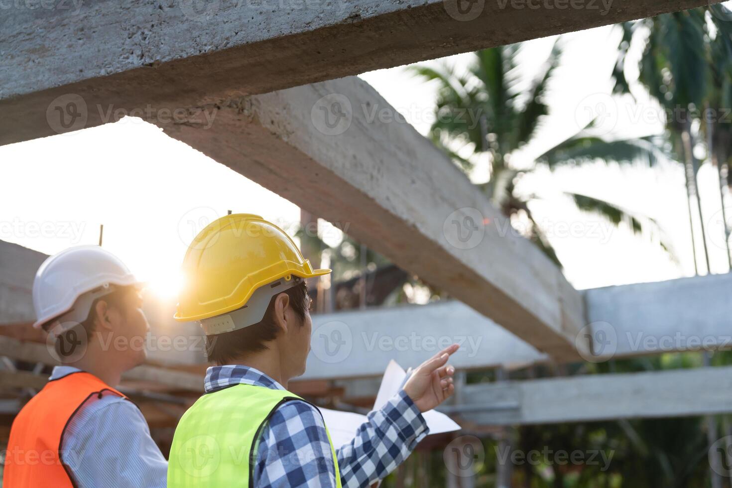 inspector or engineer is inspecting construction and quality assurance new house using a blue print. Engineer or architects or contactor work to build the house before handing it over to the homeowner photo