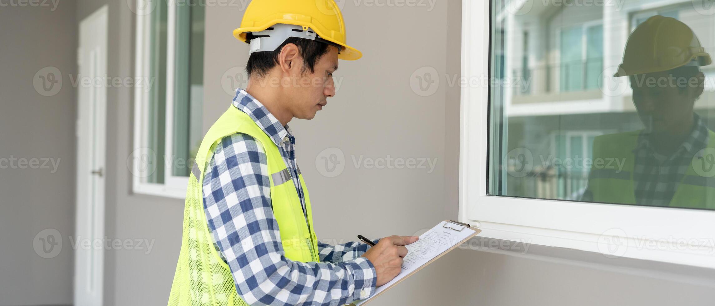 inspector or engineer is inspecting construction and quality assurance new house using a checklist. Engineers or architects or contactor work to build the house before handing it over to the homeowner photo