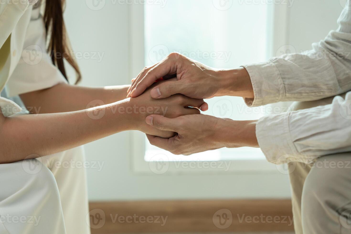 psychiatrist hold hand support each while discussing family issues. doctor encourages and empathy man suffers depression. psychological, save divorce, Hand in hand together, trust, care photo