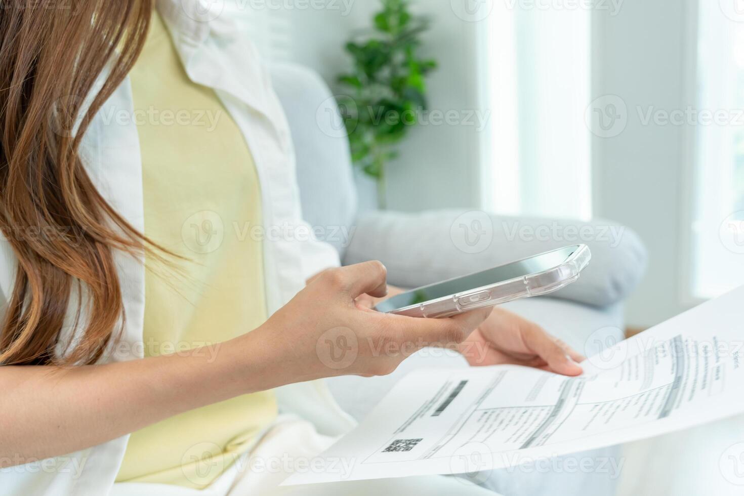 Modern woman use phone to scan barcode or QR codes to pay credit card bill after receive document invoice. payment, receive, paying electricity, digital payments without money, technology, scanning photo